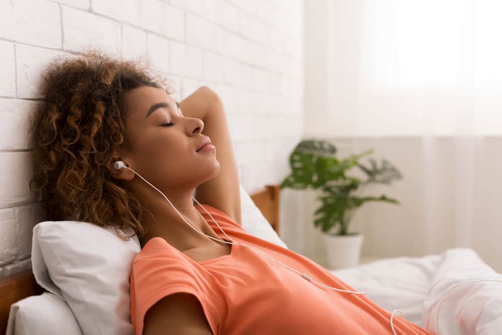 Lady relaxing with earphones - vibroacustic