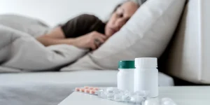 woman sleeping with zopiclone pills on the nightstand
