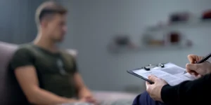 Can Cocaine Cause Psychosis? An image of a man sitting in an mental health assessment